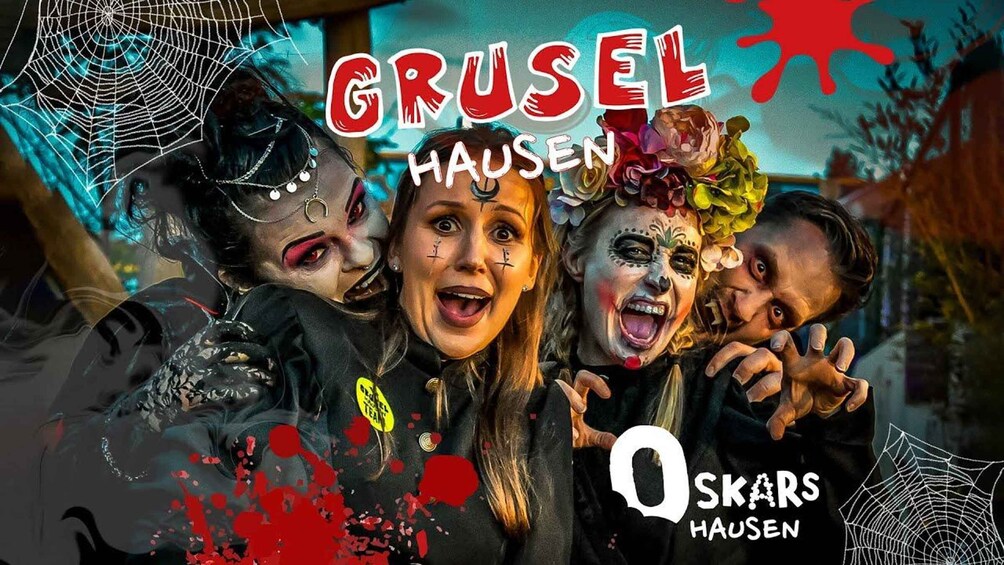 A group of people with painted faces and costumes, including a spider web and a skull, with the text 'GRUSEL HAUSEN' and '0 SKAR HAUSEN'. 1
