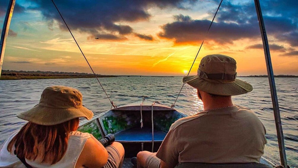 Two people on a boat during sunset. 4