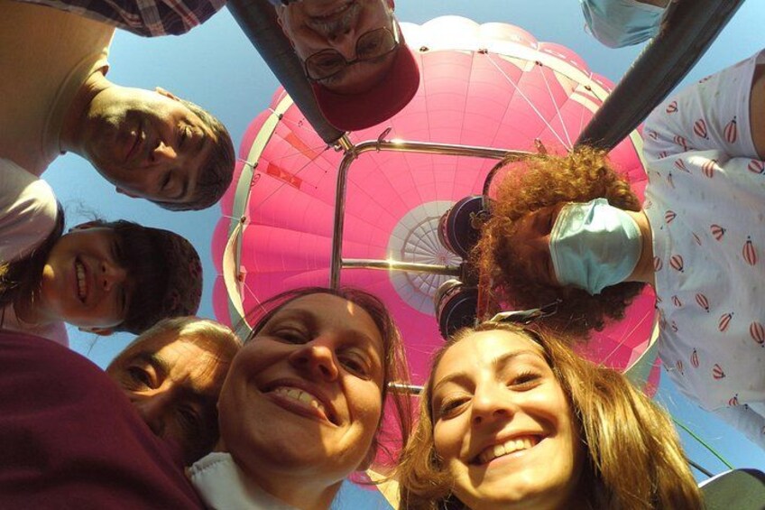 En gruppe mennesker ser op på en lyserød luftballon. 2