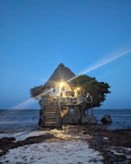 A house on stilts by the sea at dusk. 5