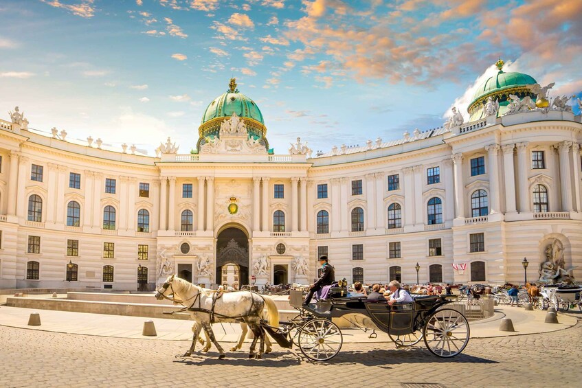 A grand building with a green dome and classical architecture. 5