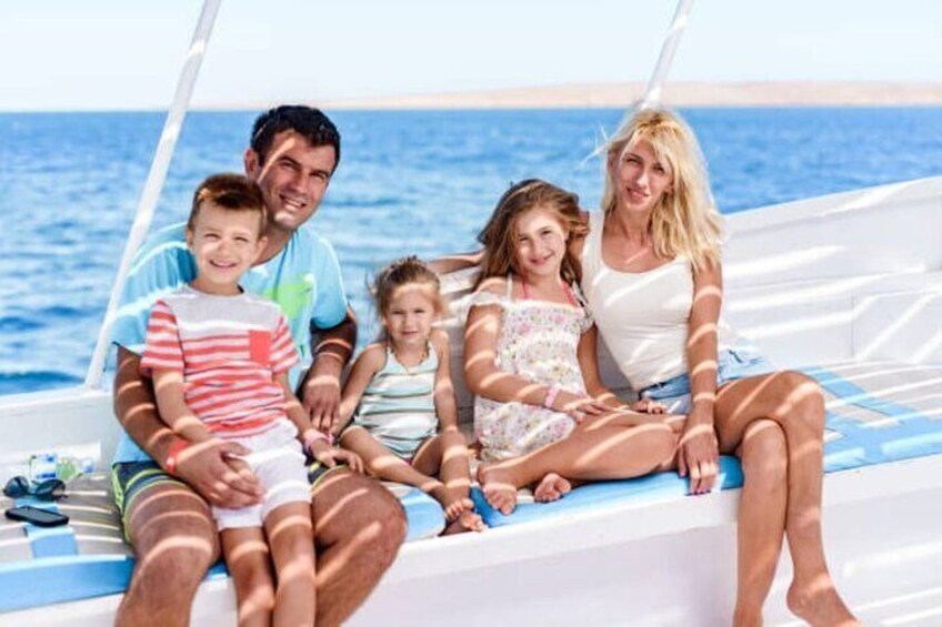 A family on a boat with the sea in the background. 1