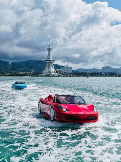 A red sports car driving on water with a lighthouse and buildings in the background. 2