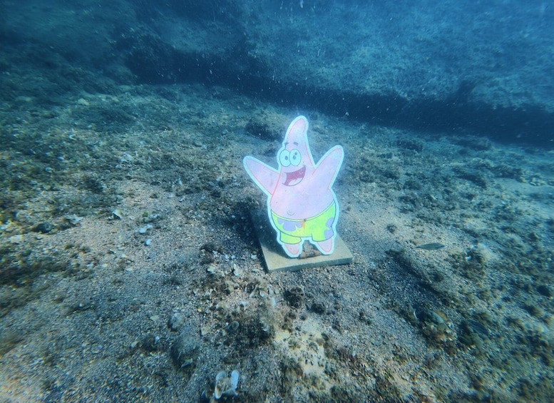 A cartoon character on a platform underwater. 5