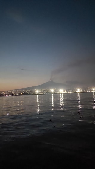 A nighttime view of a city with a mountain in the background. 3