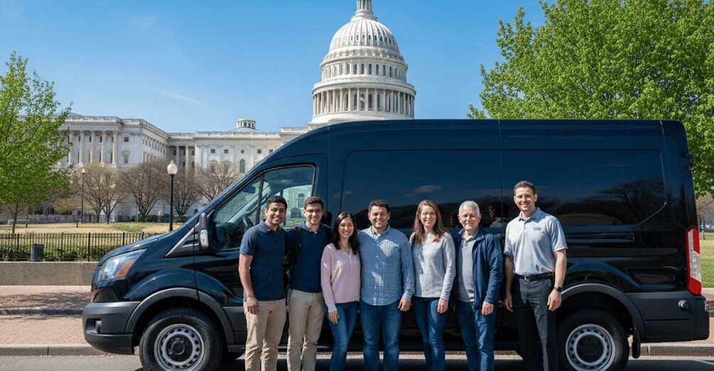 A group of people standing in front of a black van with the United States Capitol building in the background. 1