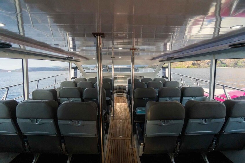 A boat interior with rows of seats and a wooden deck. 3