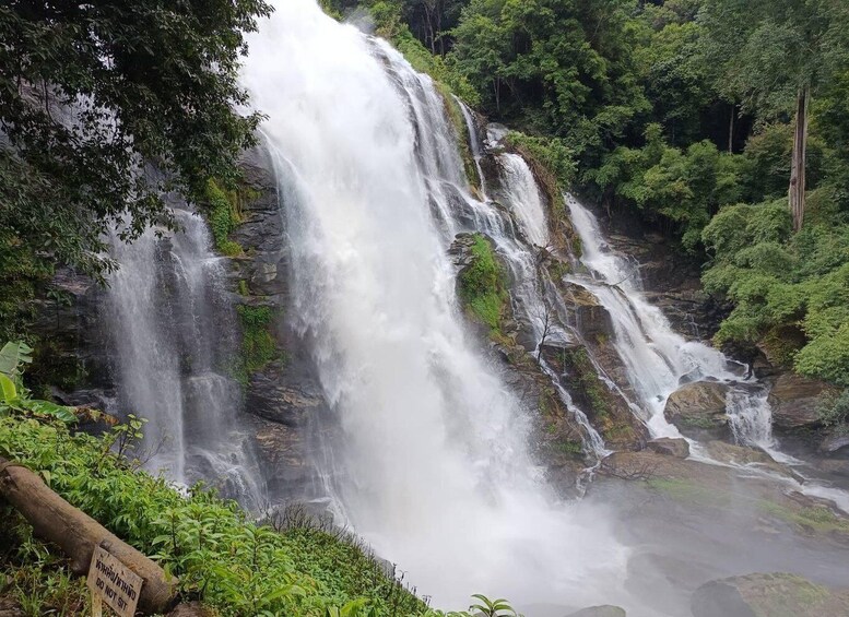 A multi-tiered waterfall surrounded by lush greenery. 2