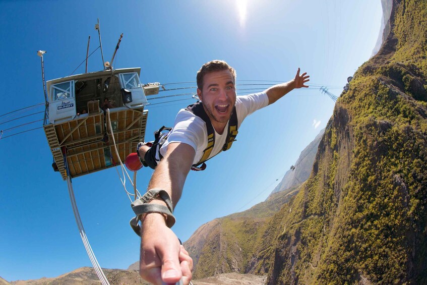 A person bungee jumping with a cable car in the background. 3