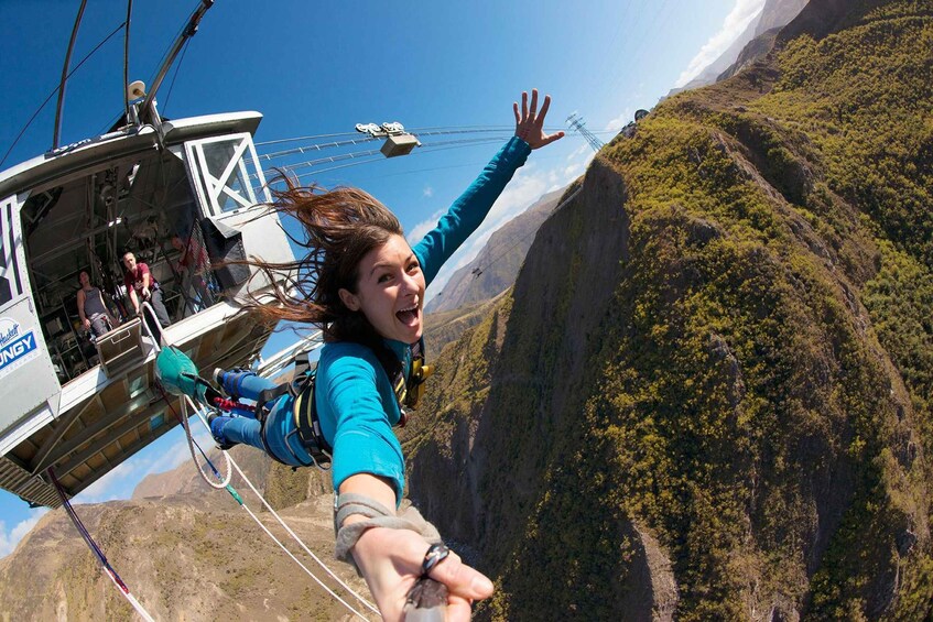 A person bungee jumping from a cable car. 2