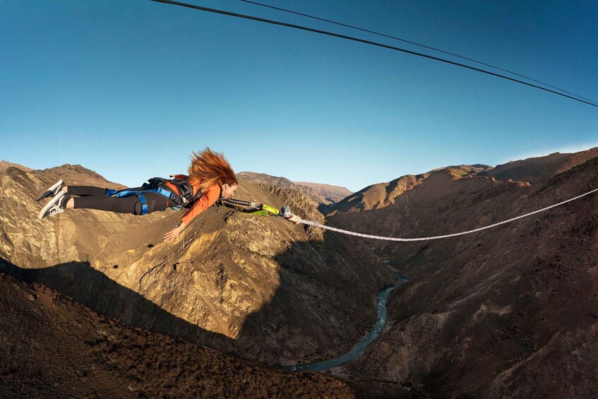 A person bungee jumping from a mountain cliff. 5