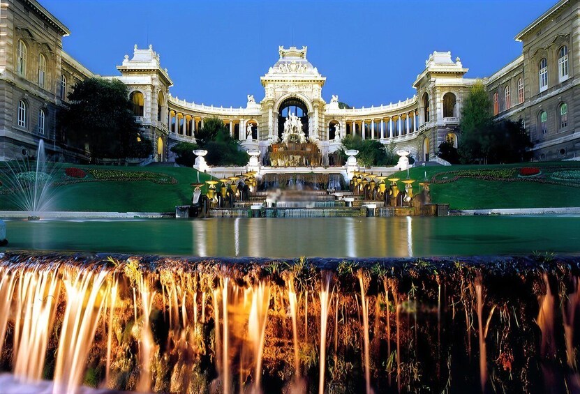 A grand building with a central fountain, surrounded by manicured gardens and a reflective pool. 5