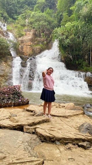 A waterfall, rocky terrain, and dense greenery. 1