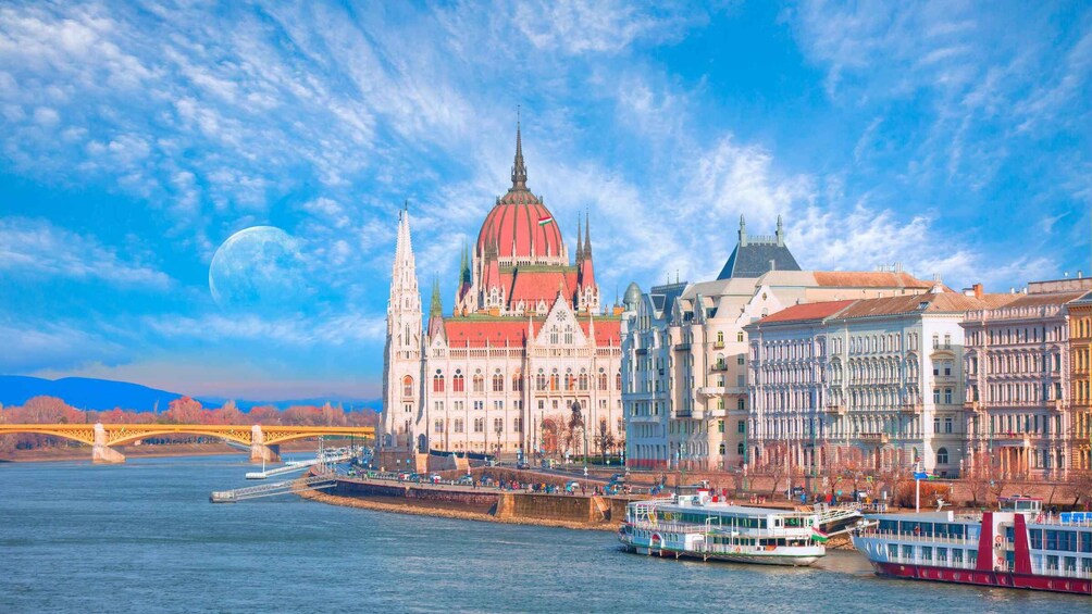 A river with a bridge and a large building with a red dome. 5