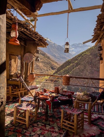 A traditional wooden interior with a view of a mountainous landscape. 2