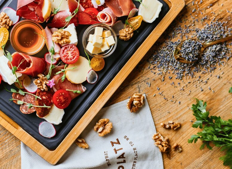 A charcuterie board with various meats, cheeses, and nuts, accompanied by a wooden cutting board and a cloth napkin. 2