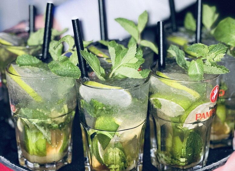 Glasses of a beverage with mint leaves and lime slices, labeled 'PAMELA.' 5