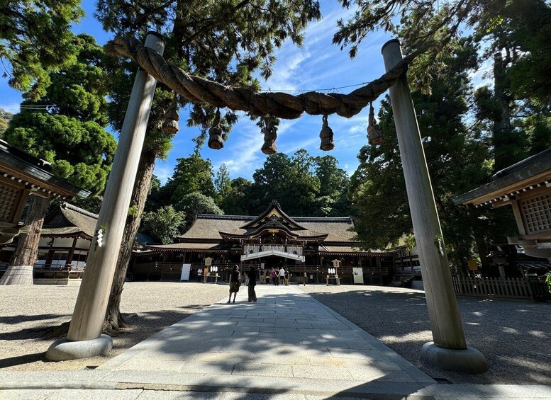 A traditional Japanese temple with a stone pathway leading to a wooden gate. 1