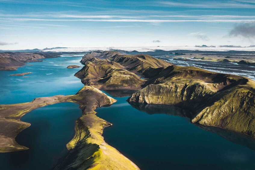 A mountainous landscape with a turquoise lake surrounded by rugged terrain. 5