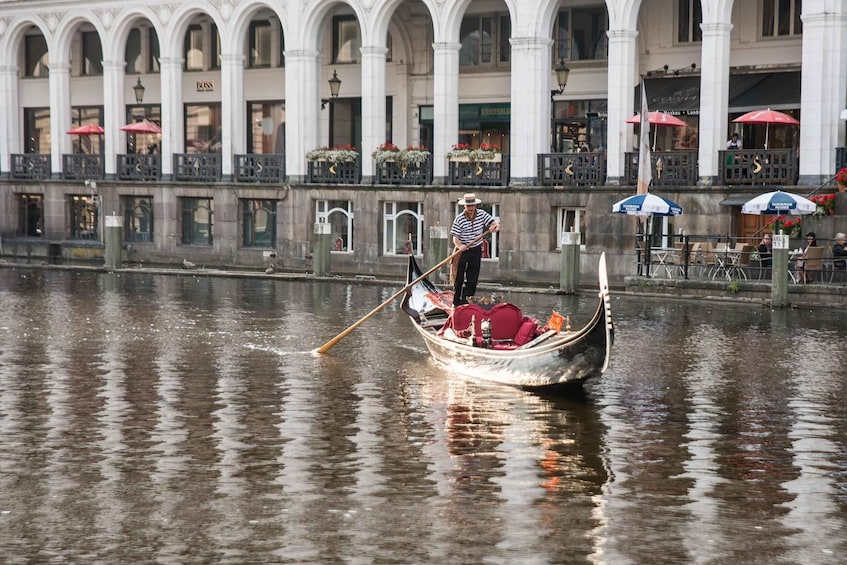 A gondola on a river with a person rowing. 3