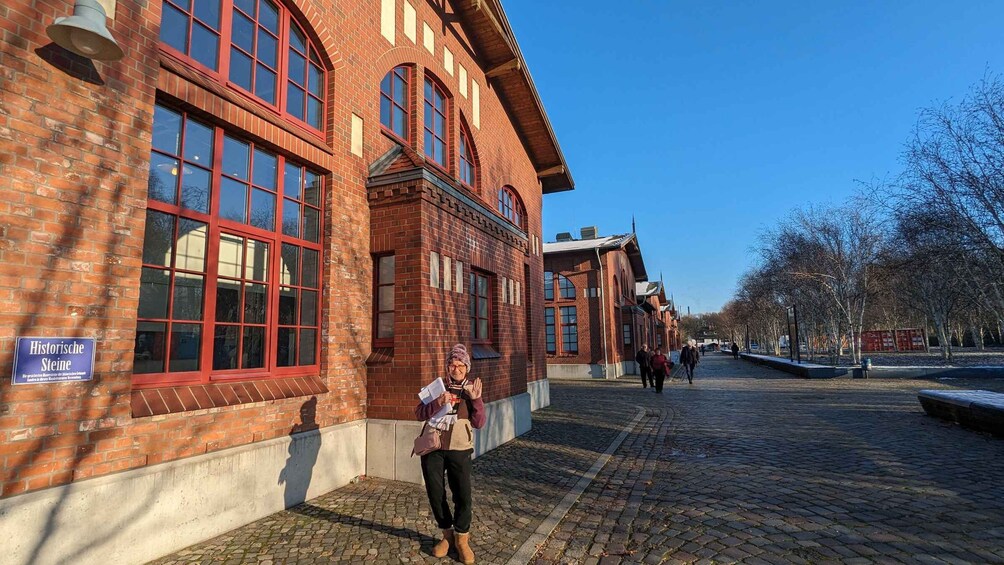 A historic building with red brick walls and large windows. 3
