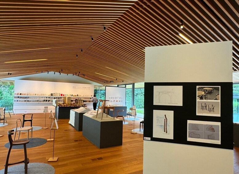 An interior space with wooden slatted ceilings, display tables, and chairs. 5