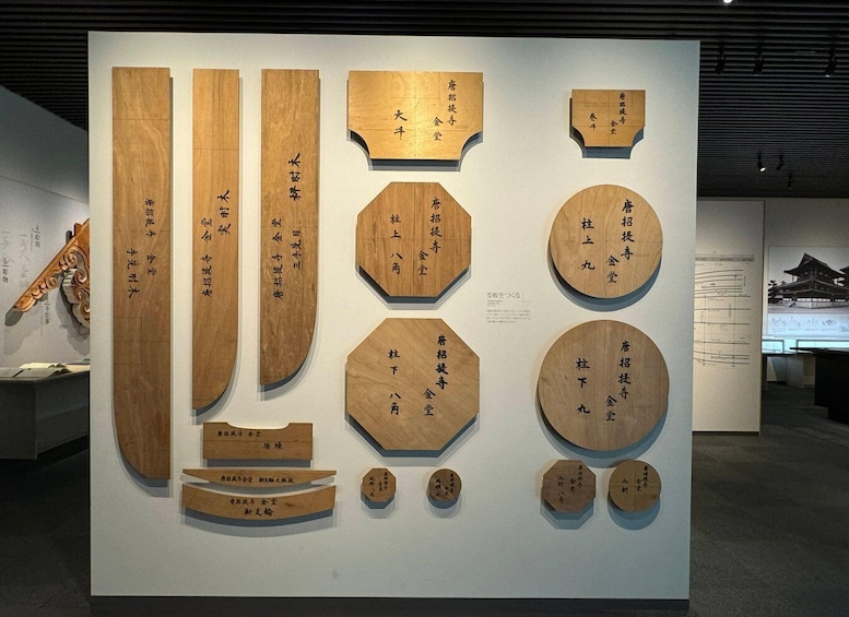 A display of wooden plaques with Japanese calligraphy. 4