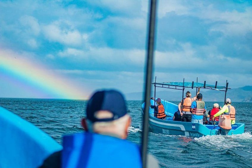 A boat with people wearing life jackets on the water. 3