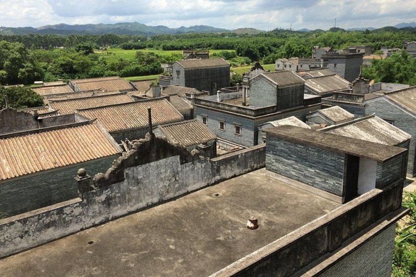A historical town with traditional buildings and a river. 1