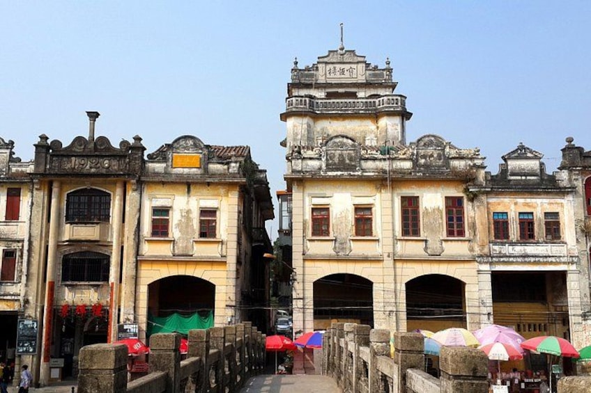 Historic buildings with ornate facades and a traditional archway. 4