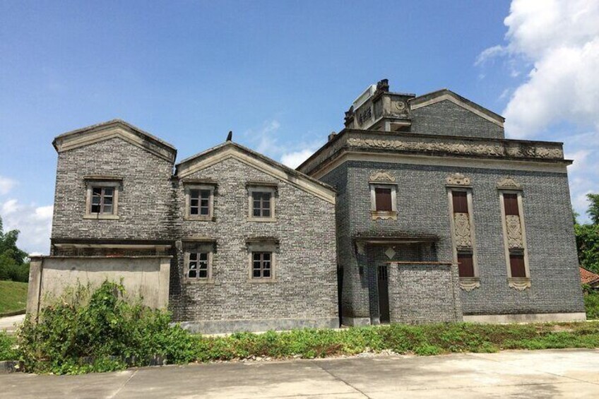 A large stone building with multiple windows and a prominent entrance. 5