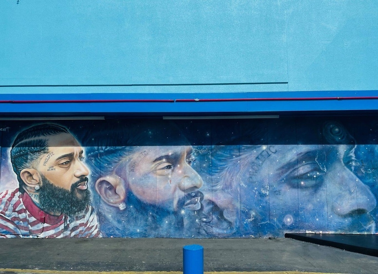A mural on a building with a blue sky background. 1