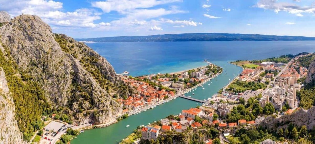 A coastal town with a marina, a mountain, and a bay. 4