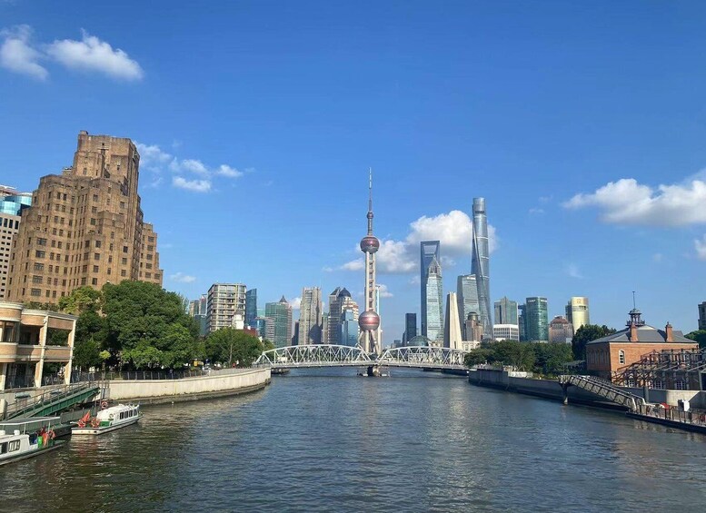 A river with a bridge, a tower, and modern skyscrapers in the background. 5