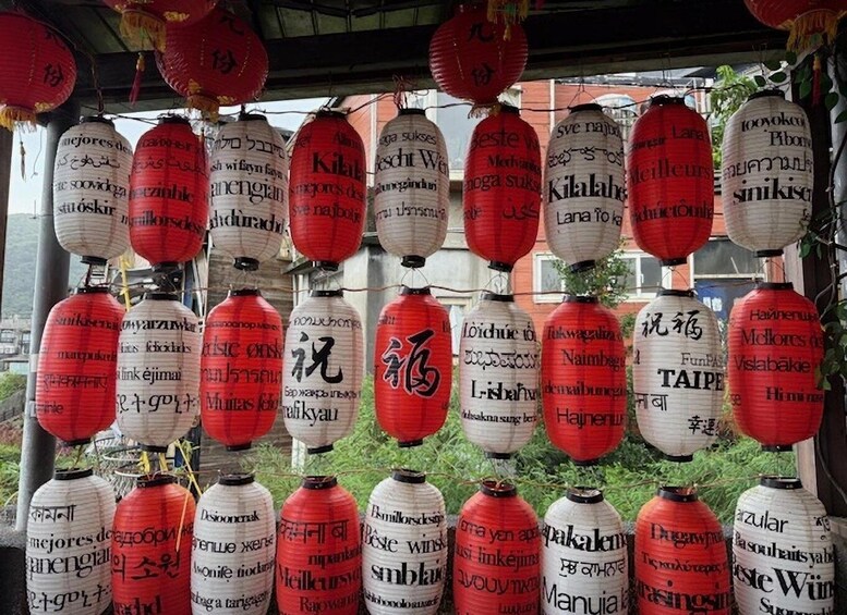 A row of red and white paper lanterns with text in various languages. 3