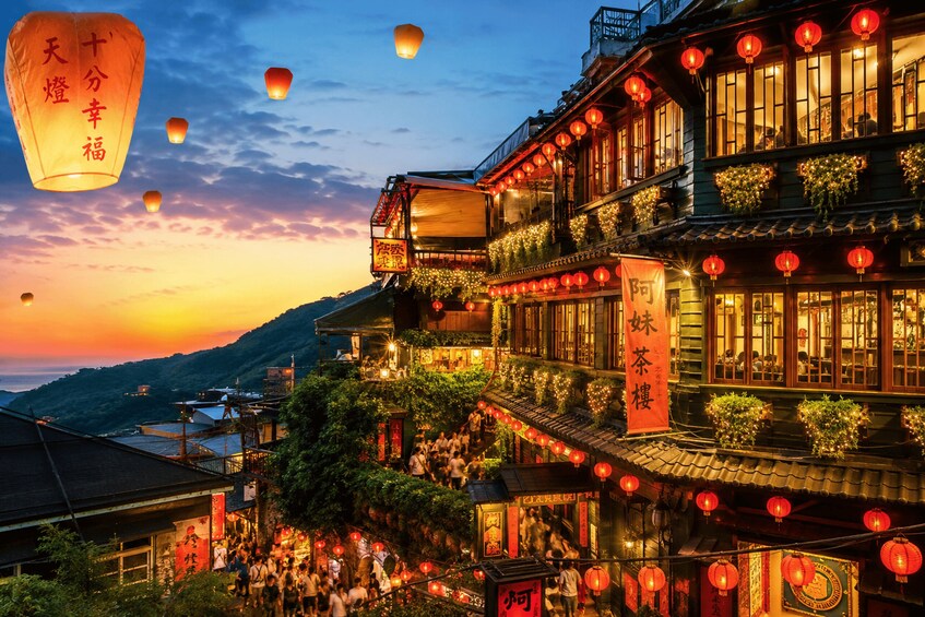 A traditional Chinese building with red lanterns and a signboard. 2