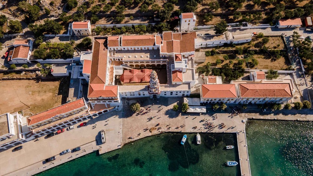 An aerial view of a coastal town with buildings, a marina, and clear waters. 5