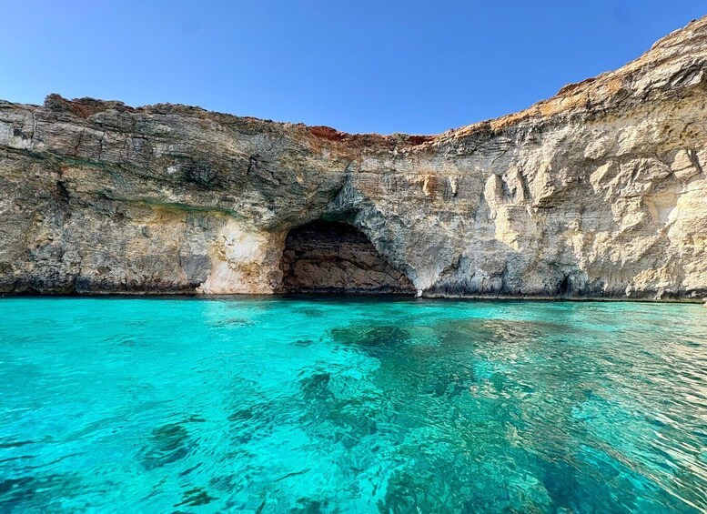 A coastal cave entrance with clear turquoise water. 3