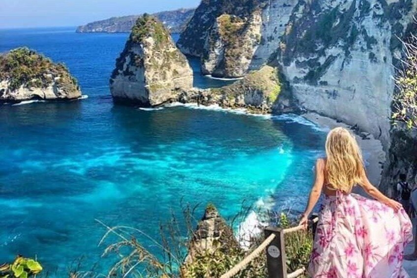 A coastal landscape with cliffs and clear blue waters. 2