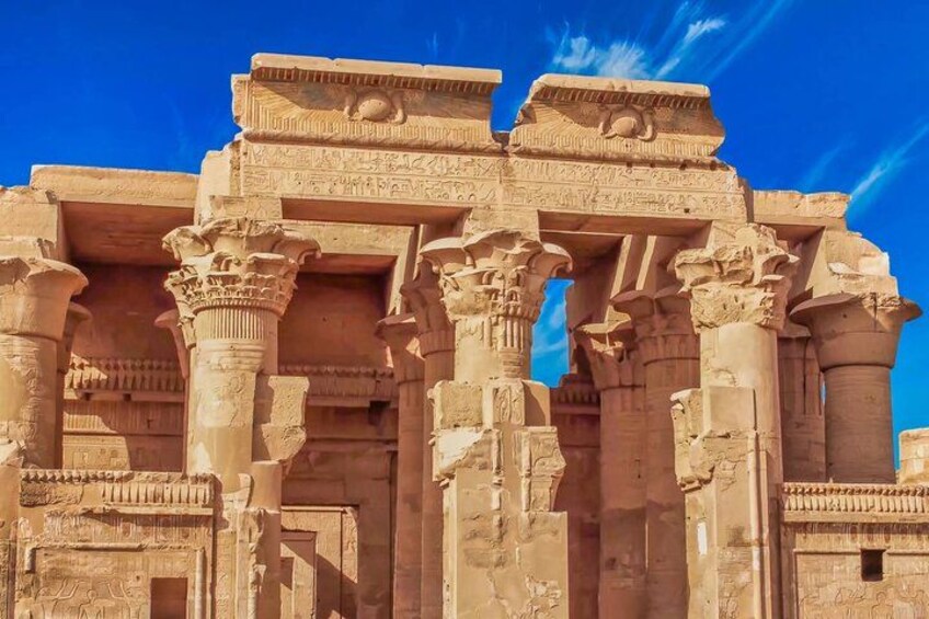 Ancient stone architecture with columns and intricate carvings. 3