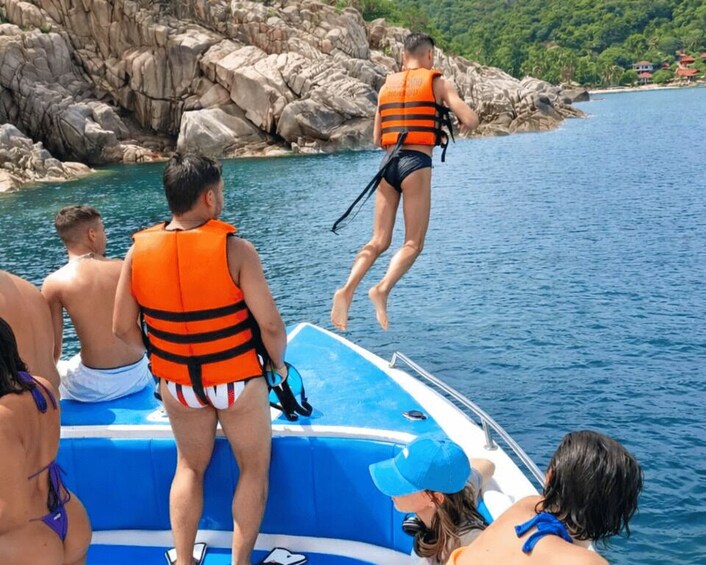People on a boat, some wearing life jackets, preparing to jump into the water. 4