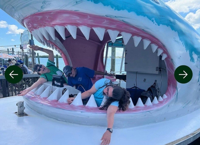 A large shark mouth sculpture with people inside. 1