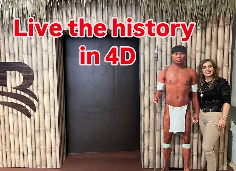 A man and a woman standing in front of a door with a bamboo backdrop and a large 'B' sign. 1