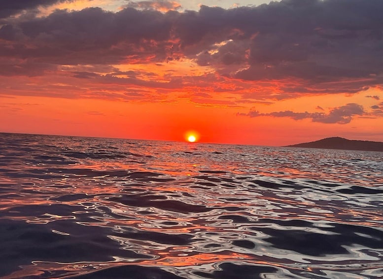 A sunset over the ocean with waves reflecting the sky's colors. 4