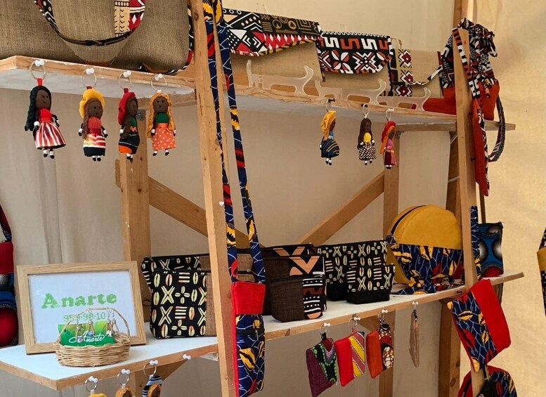 A display of colorful bags and keychains with traditional patterns. 2
