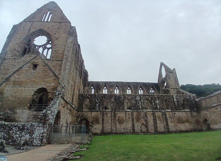 An ancient stone church with Gothic architecture, including pointed arches and a large rose window. 2