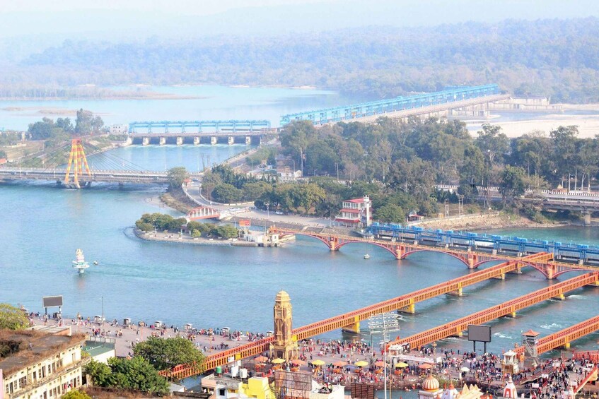 A river with bridges, a clock tower, and a busy waterfront area. 3