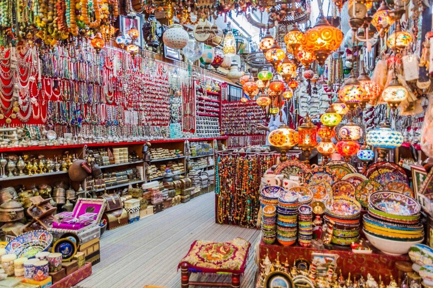 A vibrant market with colorful textiles, intricate jewelry, and traditional lamps. 3