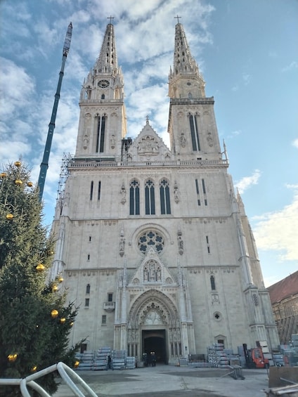 A cathedral with two tall spires and a large central rose window. 1