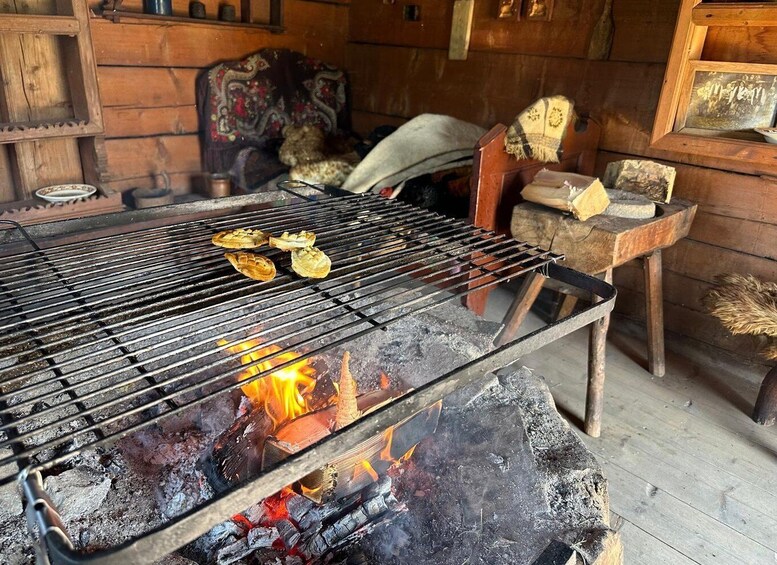 A grill with food being cooked over an open fire. 4
